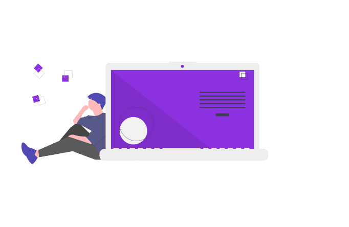 A man sitting beside a giant laptop.